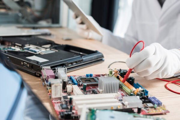 Technician repairing a laptop motherboard at Palak Infotech, Chandigarh